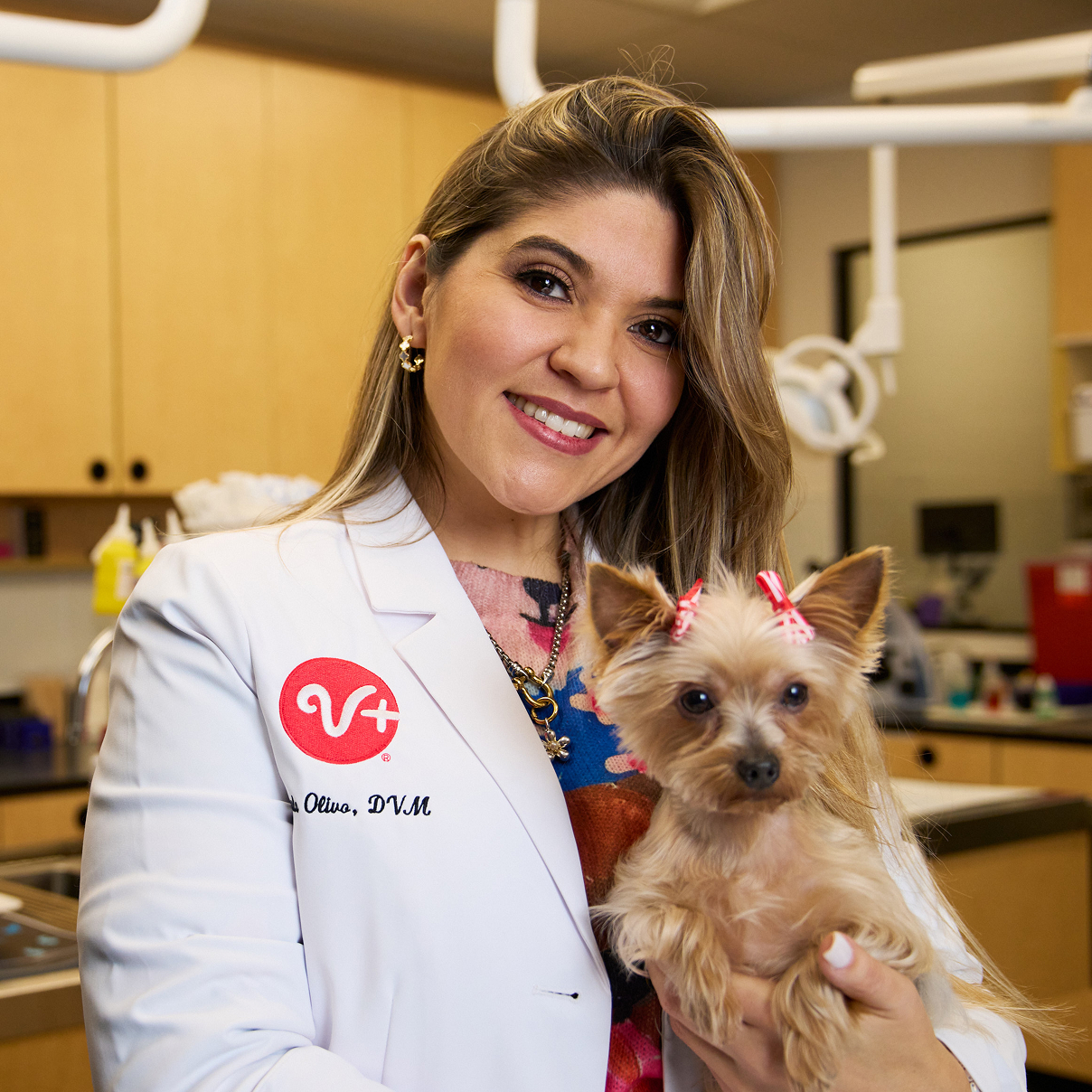 A veterinarian poses with arms crossed.