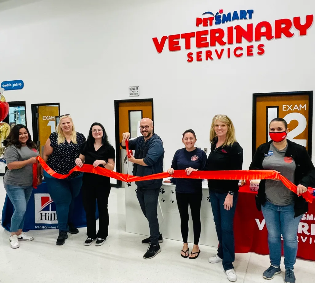 Vet team cutting the ribbon in front of PVS area in store
