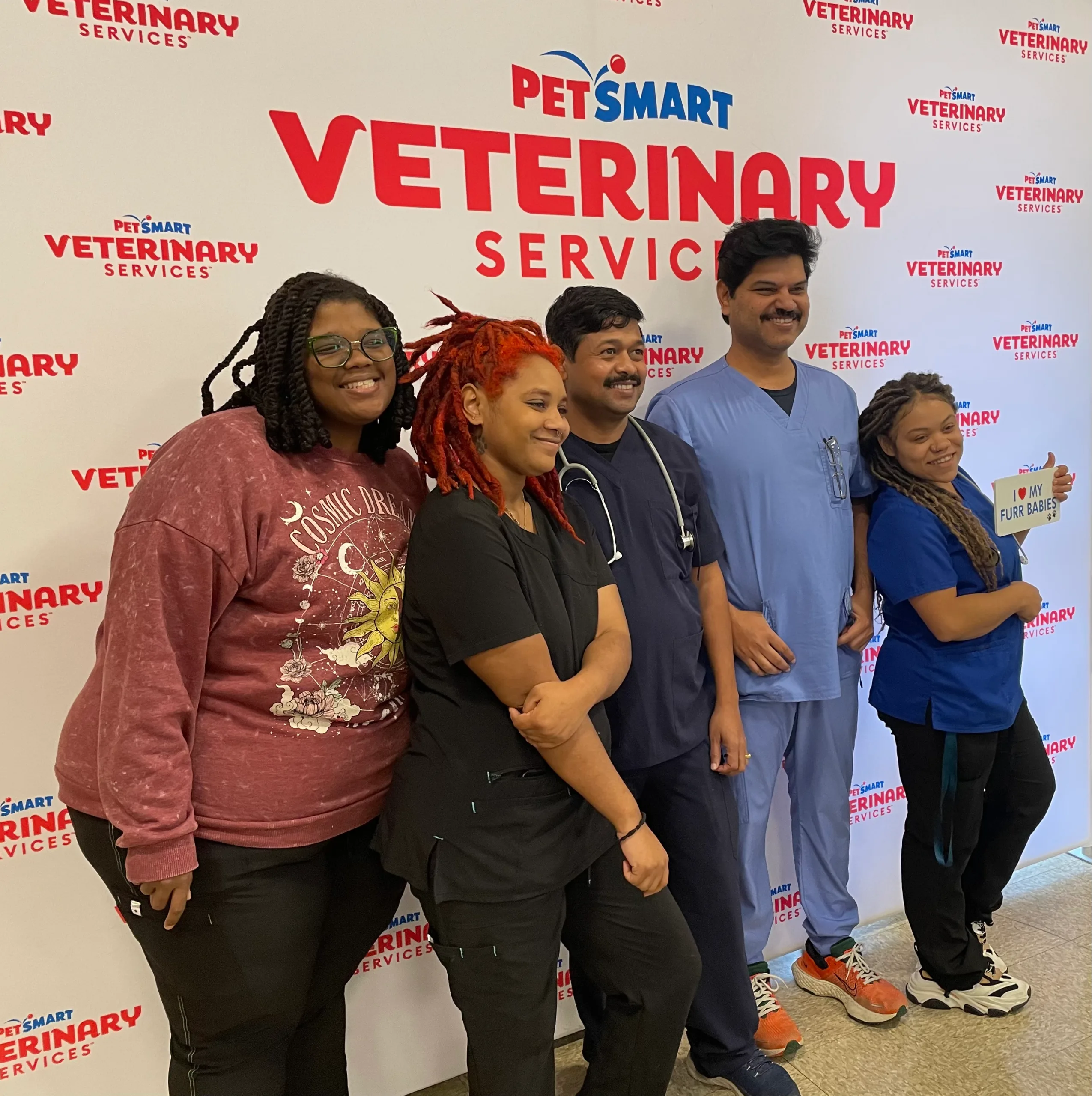 Team standing in front of pvs logo board