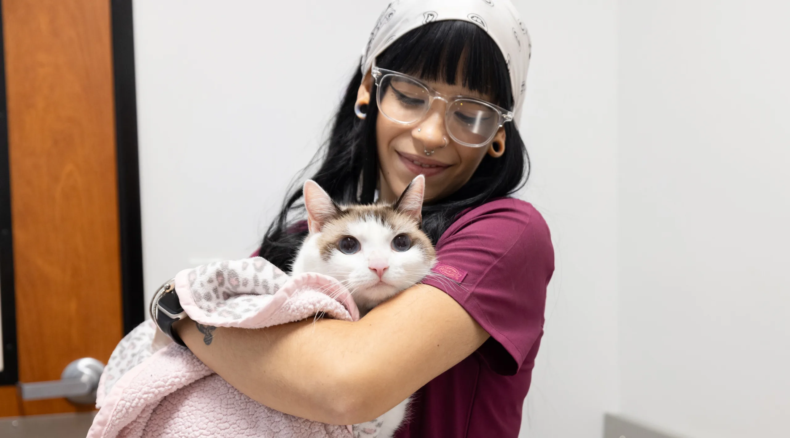 Vet tech holding a cat